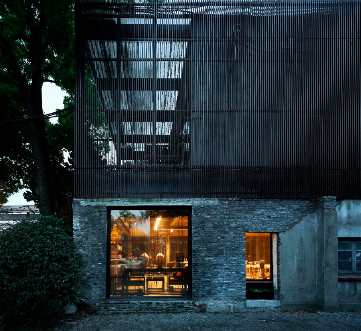 A red cedar grill placed on mottled worn walls of Ceramic House to preserve authenticity