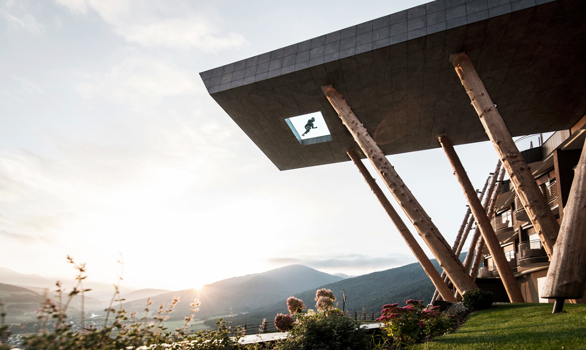 NOA’s Hubertus Hotel in Italy features cantilevering pool looking natural topography of the town