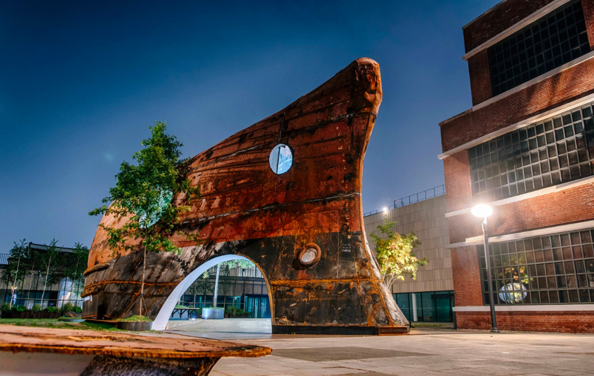 This upside down massive metal pavilion is made of recycled steel parts from an old ship by Shinslab
