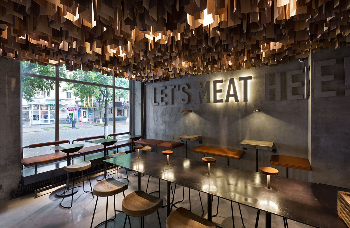 YOD Design Studio hangs thousands of wooden sticks from the ceiling of Burger Joint in Ukraine