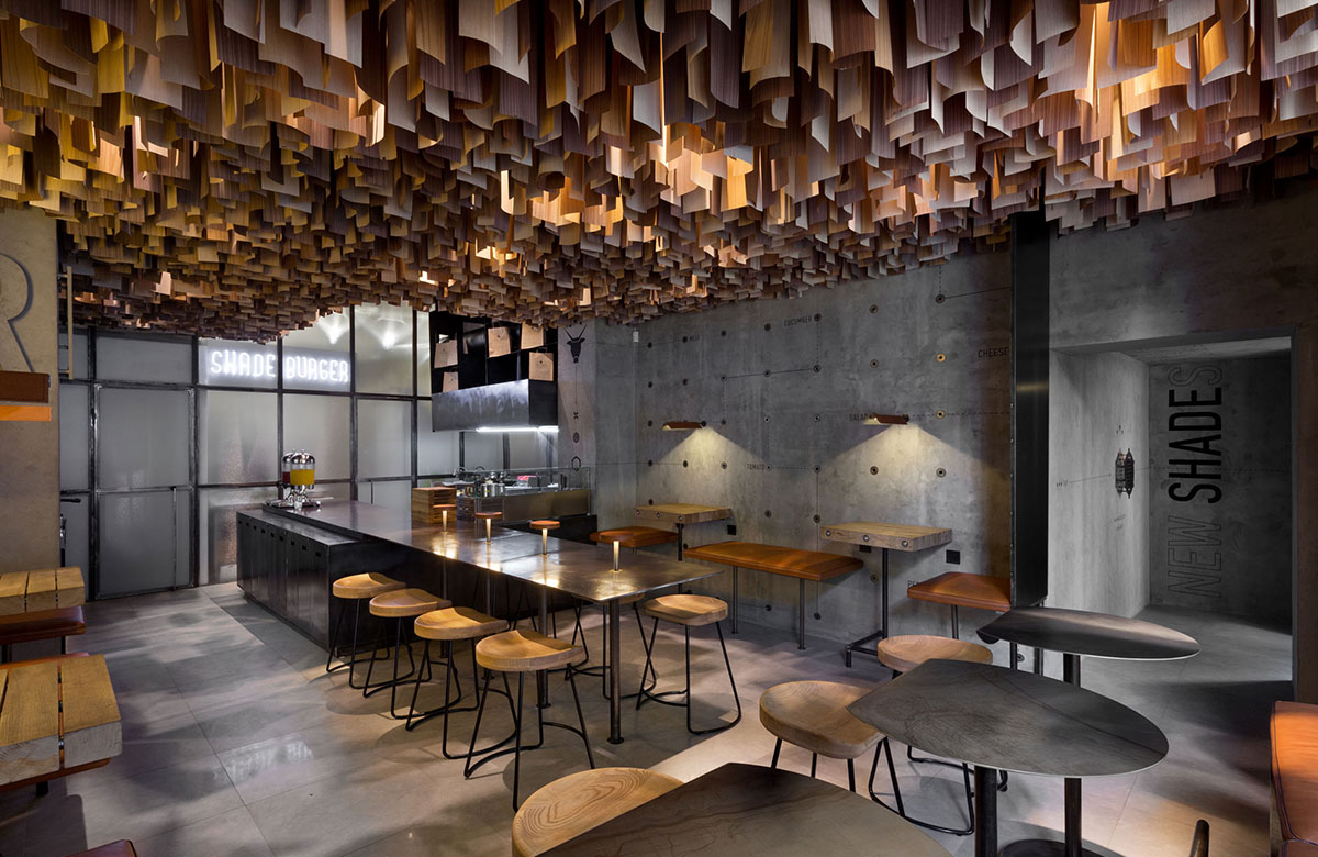YOD Design Studio hangs thousands of wooden sticks from the ceiling of Burger Joint in Ukraine