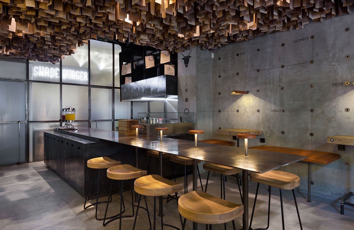 YOD Design Studio hangs thousands of wooden sticks from the ceiling of Burger Joint in Ukraine