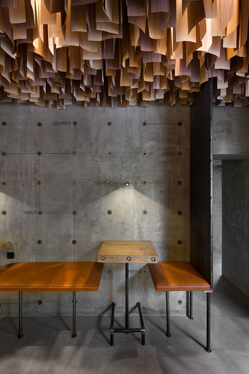 YOD Design Studio hangs thousands of wooden sticks from the ceiling of Burger Joint in Ukraine