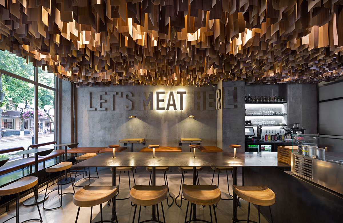 YOD Design Studio hangs thousands of wooden sticks from the ceiling of Burger Joint in Ukraine