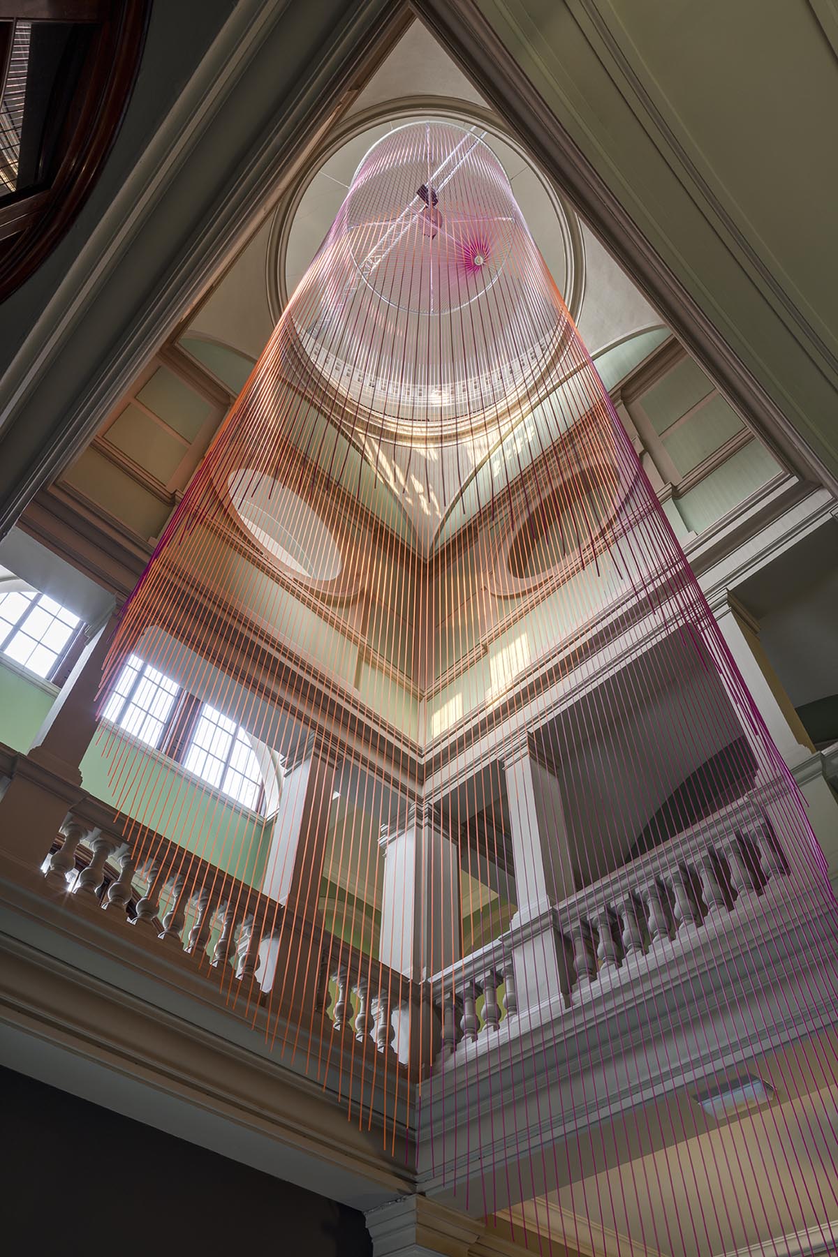 Glithero suspends an abstract version of clock at V&A made up of 160 multicoloured silicone cords