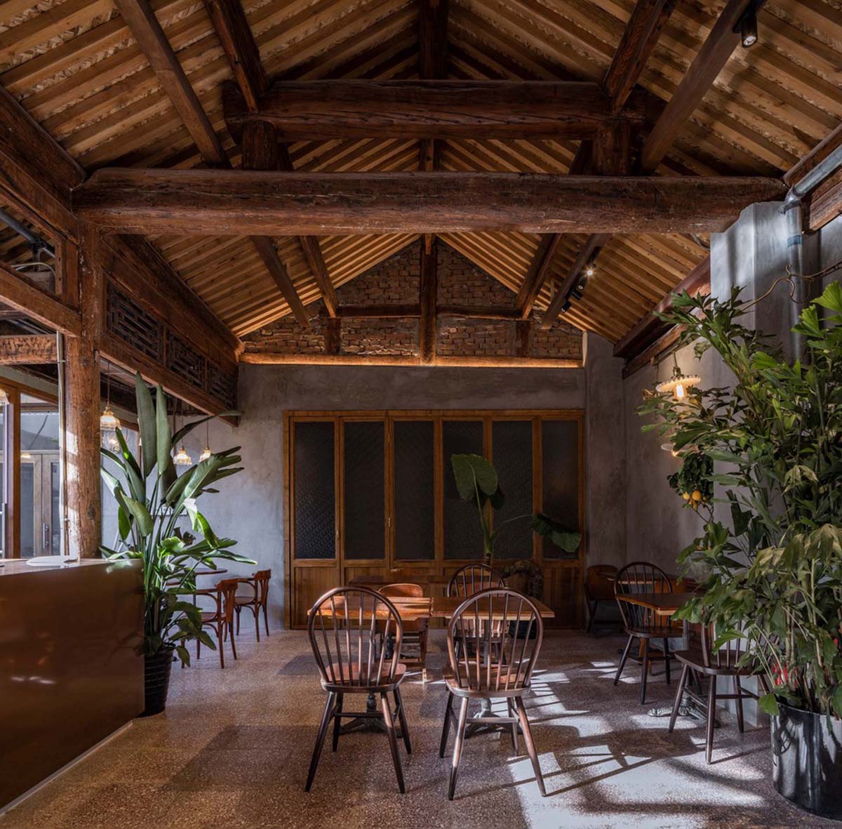 Linkchance Architects creates coffee store and art studio with golden metallic interiors in Beijing