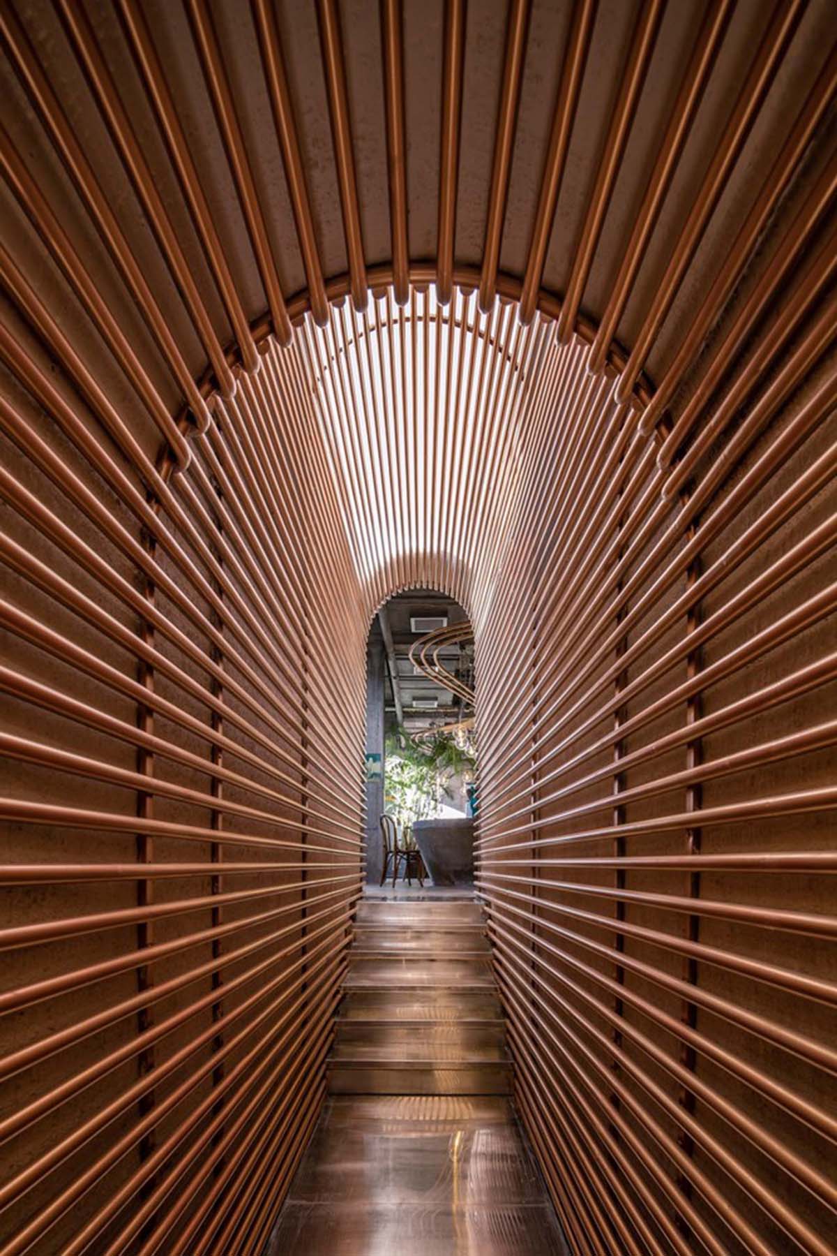 Linkchance Architects creates coffee store and art studio with golden metallic interiors in Beijing