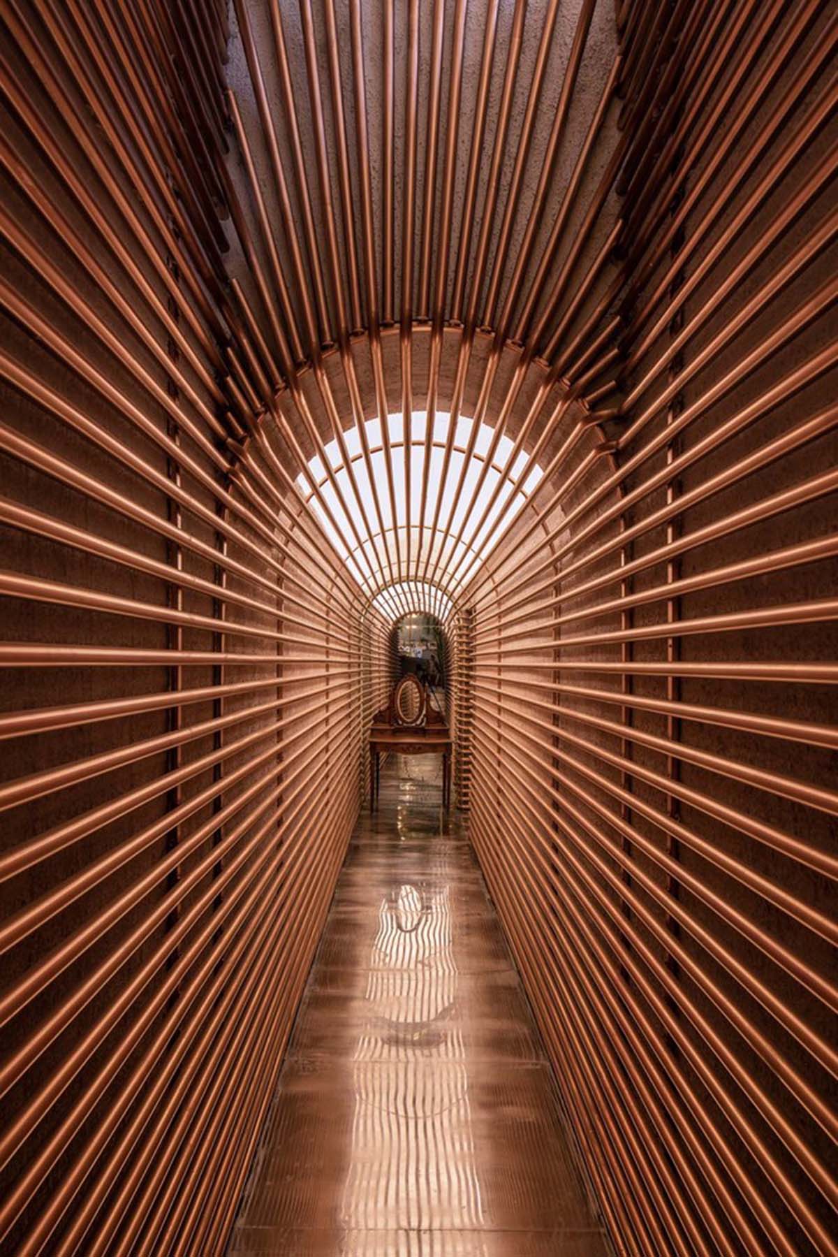 Linkchance Architects creates coffee store and art studio with golden metallic interiors in Beijing