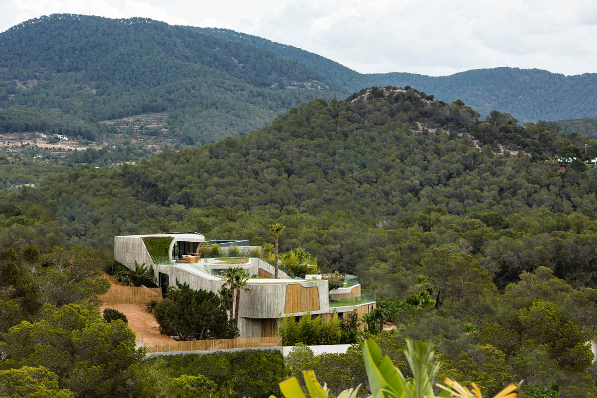 Villa Mediterraneo Ibiza adapts nature with organic form and bamboo shutters