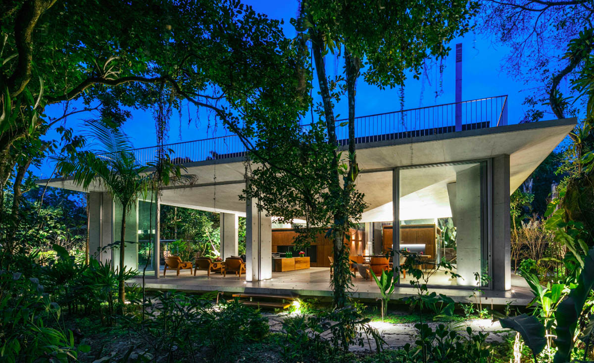 Gui Mattos created open plan for this concrete house to become a part of dense rainforest in Brazil