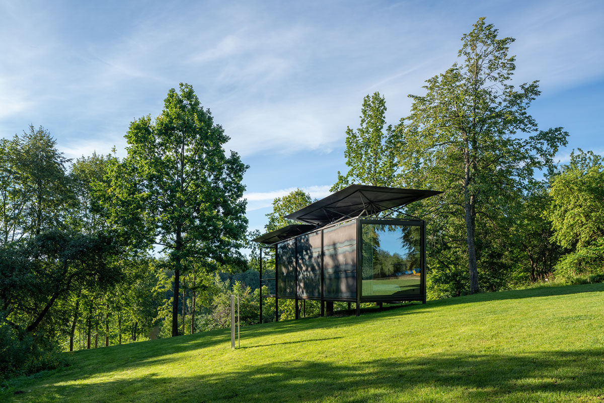 ŠA atelier designs linear black metal cabin to frame the view on natural terrain of Lithuania