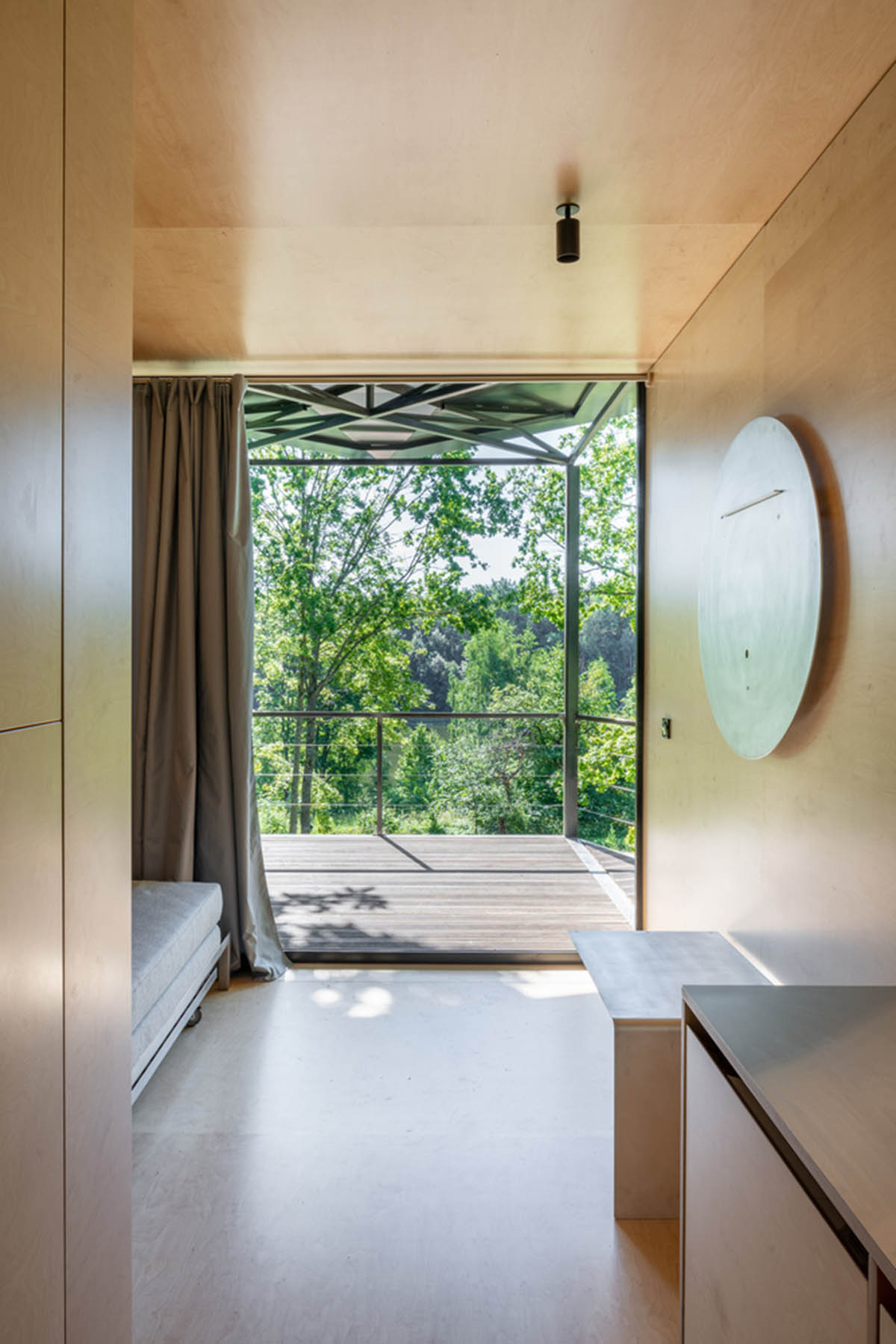 ŠA atelier designs linear black metal cabin to frame the view on natural terrain of Lithuania