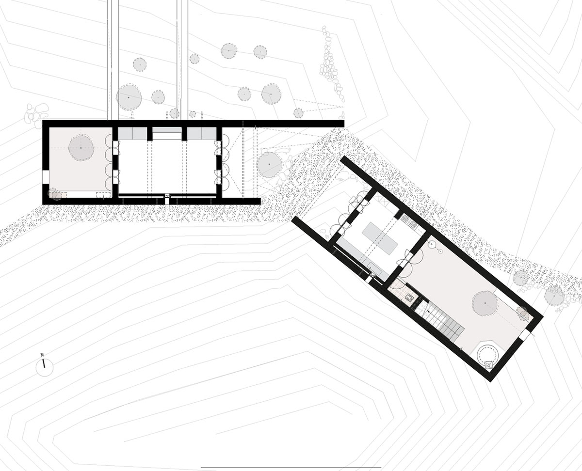 Two elongated walls made of granite rocks and earth form this women's house in a village of Morocco
