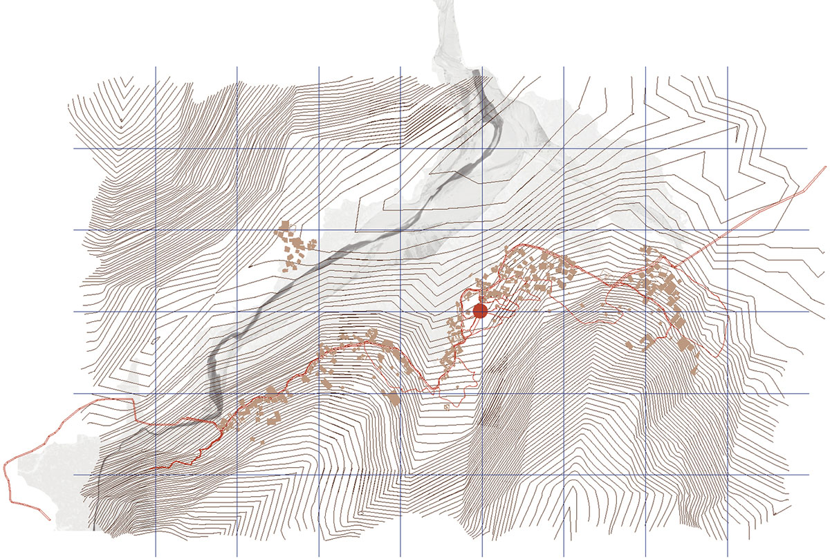 Two elongated walls made of granite rocks and earth form this women's house in a village of Morocco