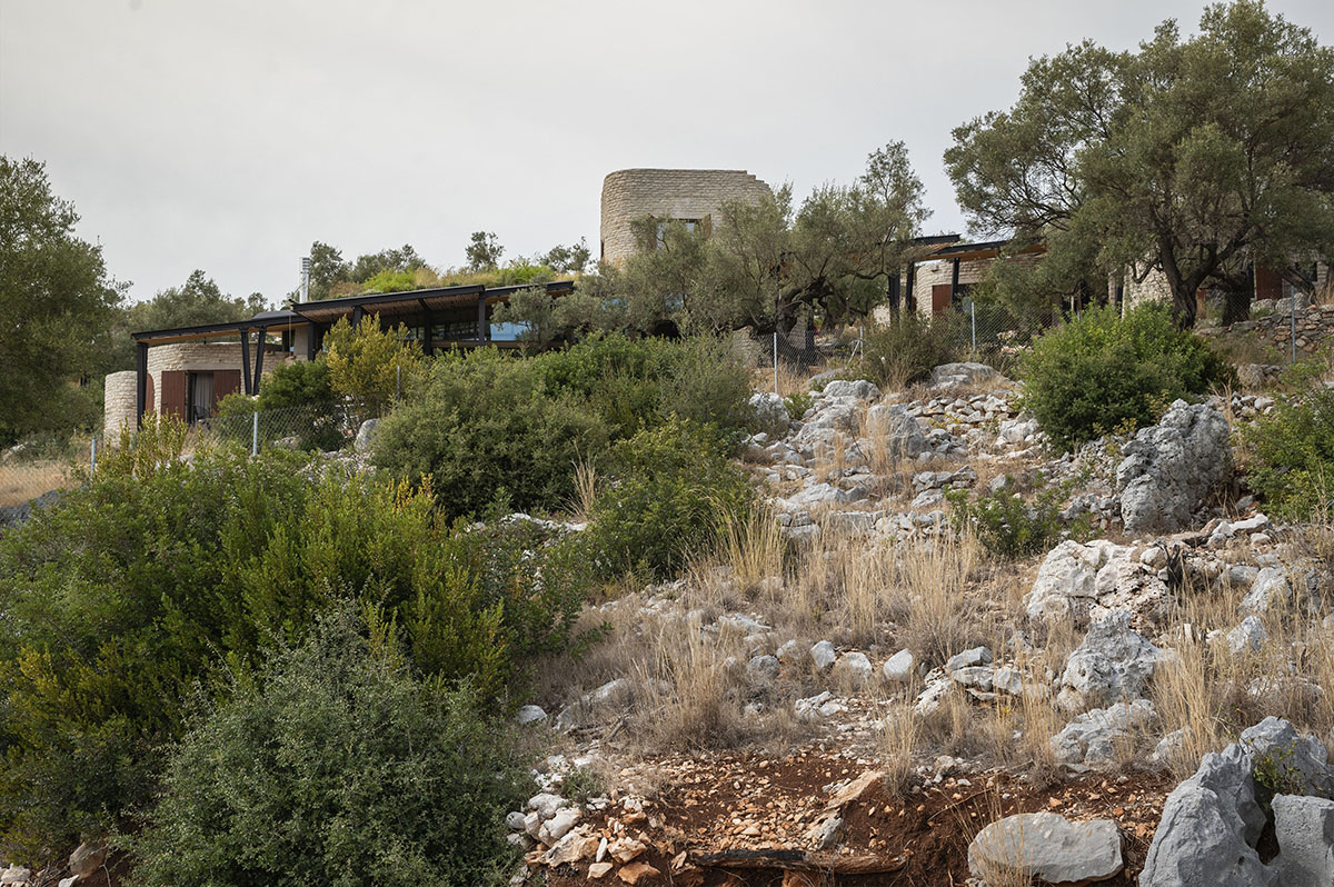 Pastoral round stone dwellings inform Meganisi House by Hiboux Architecture on Meganisi island