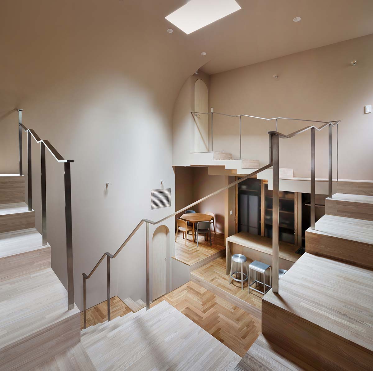 Tan Yamanouchi turns a book vault wall in studio and residence into a cozy space for cats in Japan