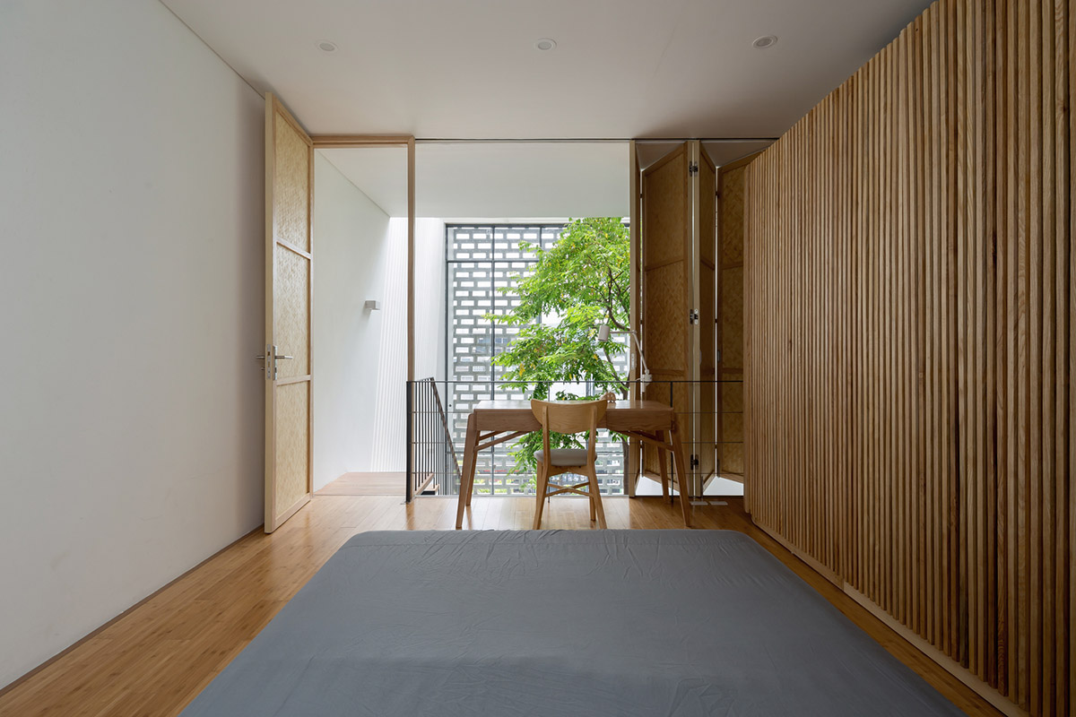 ODDO architects built this narrow house with rich interior spaces and perforated skin in Hanoi