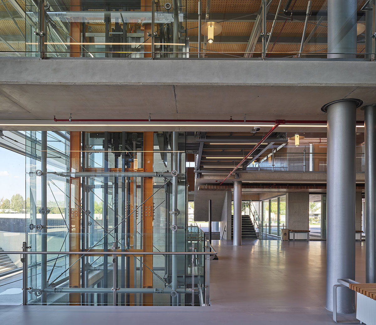 Uygur Architects articulates performing arts center façade with wooden triangulating surfaces