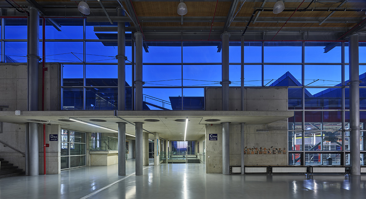 Uygur Architects articulates performing arts center façade with wooden triangulating surfaces