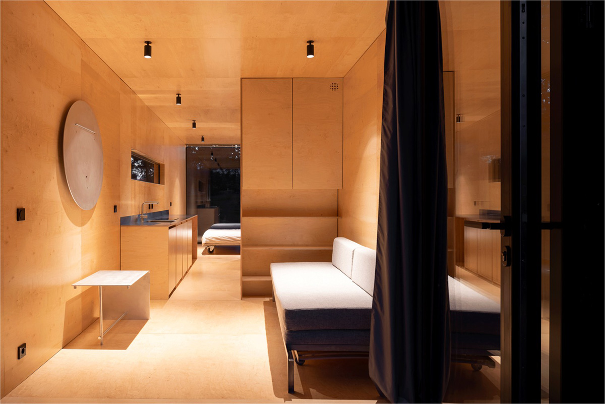 ŠA atelier designs linear black metal cabin to frame the view on natural terrain of Lithuania