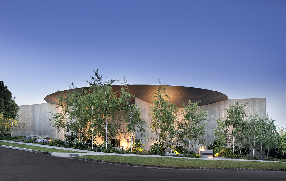 Wood Marsh built sculptural Towers Road House that features disc-shaped zinc roof in Toorak