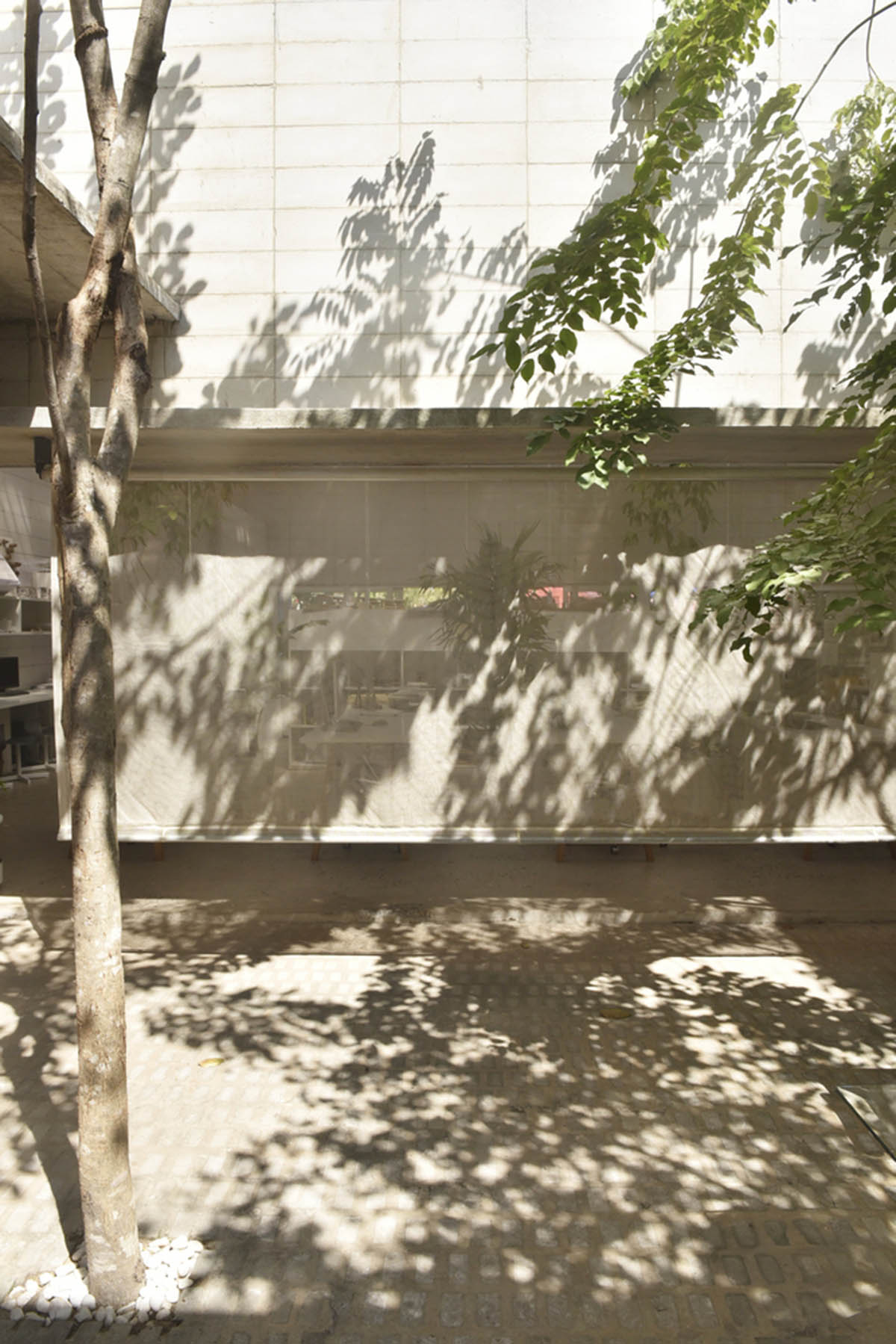 An office in Vietnam protects its own micro-climate with continuous spaces and internal courtyards