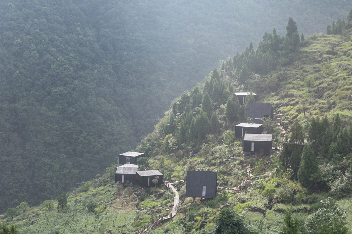 Triangular hotel cabins are scattered in a green village of Guizhou to help agricultural tourism
