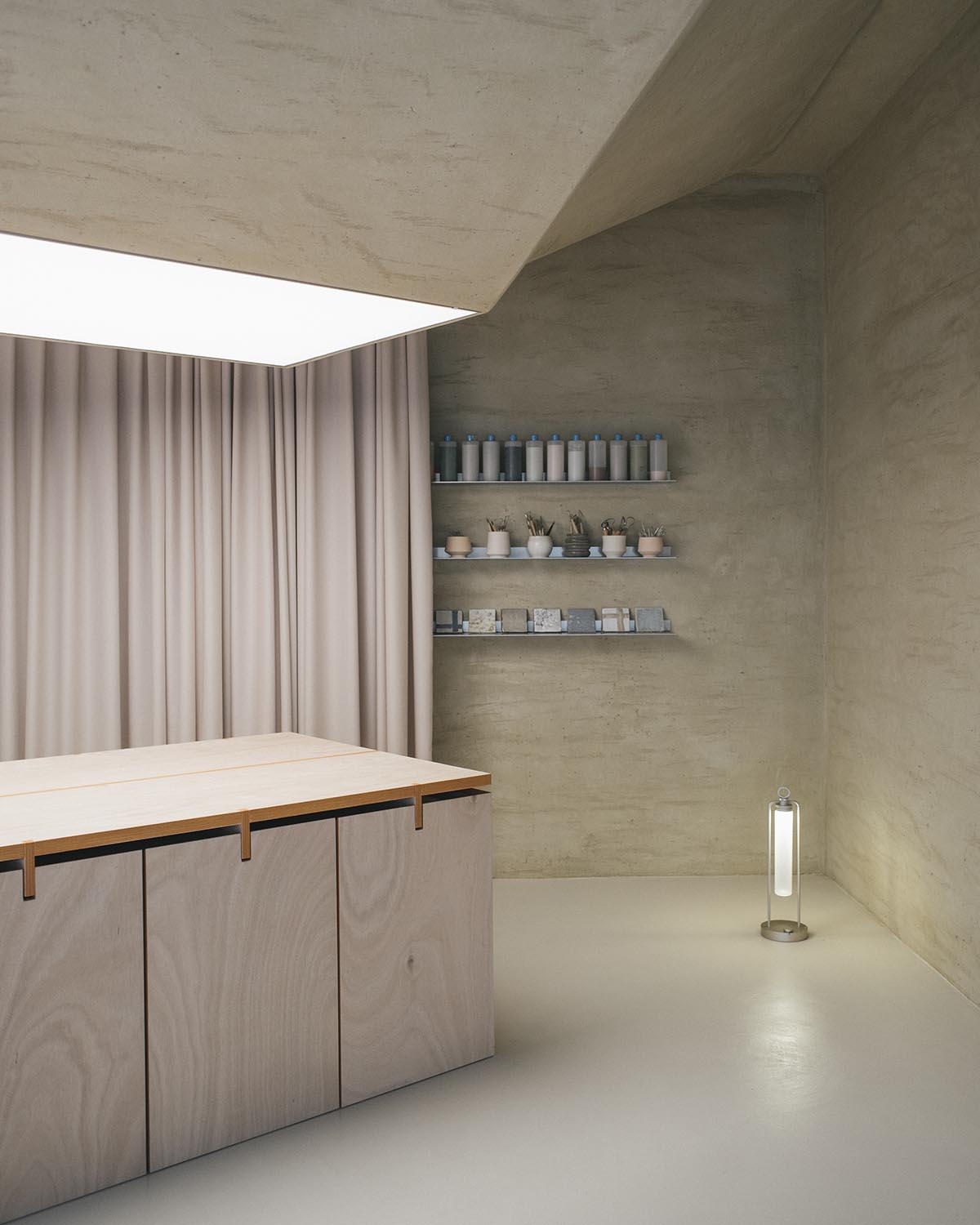 The interior of a workshop brings a zenithal light with the potter's wheel-like ceiling