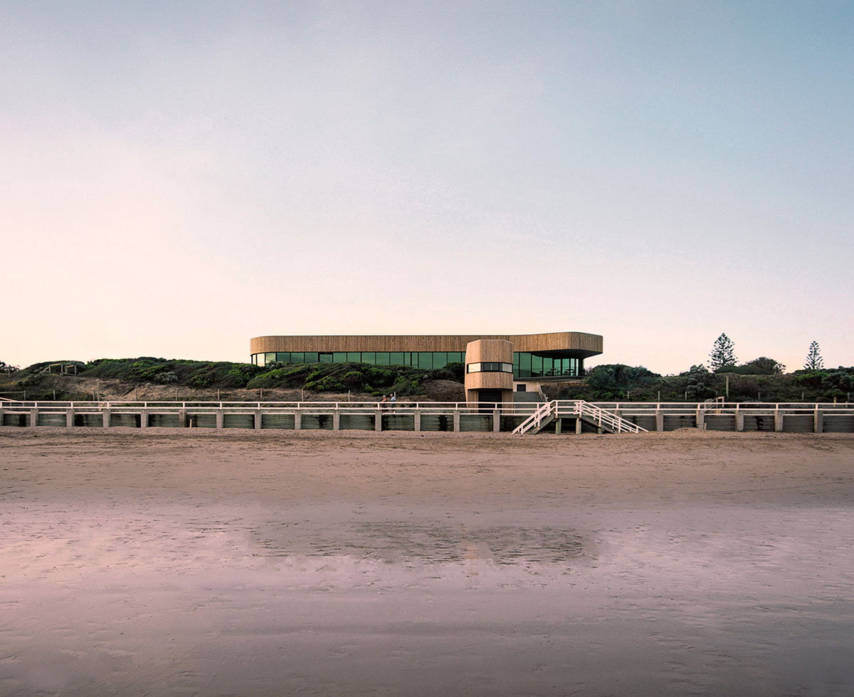 Wood Marsh completes surf club with timber rounded corners echoing ocean and eroded dunes