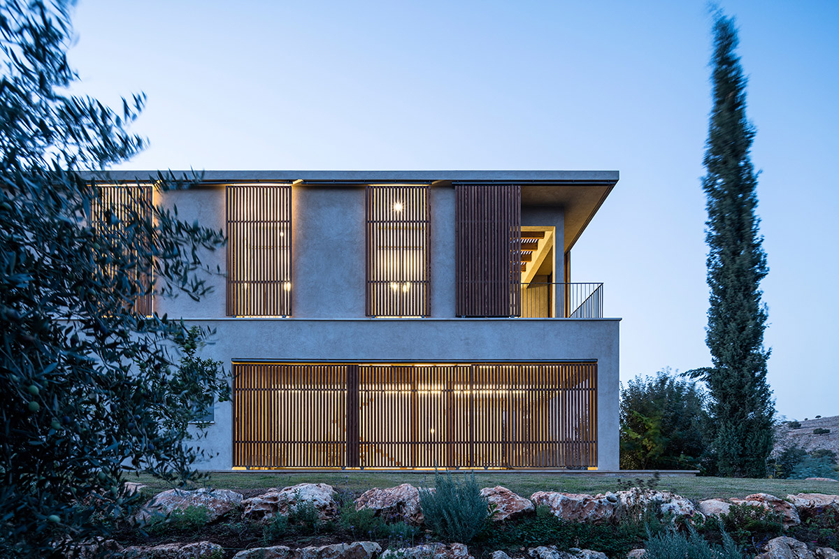 Golany Architects completes concrete private residence with wooden shutters in the Galilee