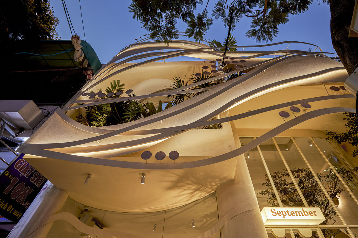 September Cafe is designed to look like a bird's nest with curved steel stripes in Vietnam