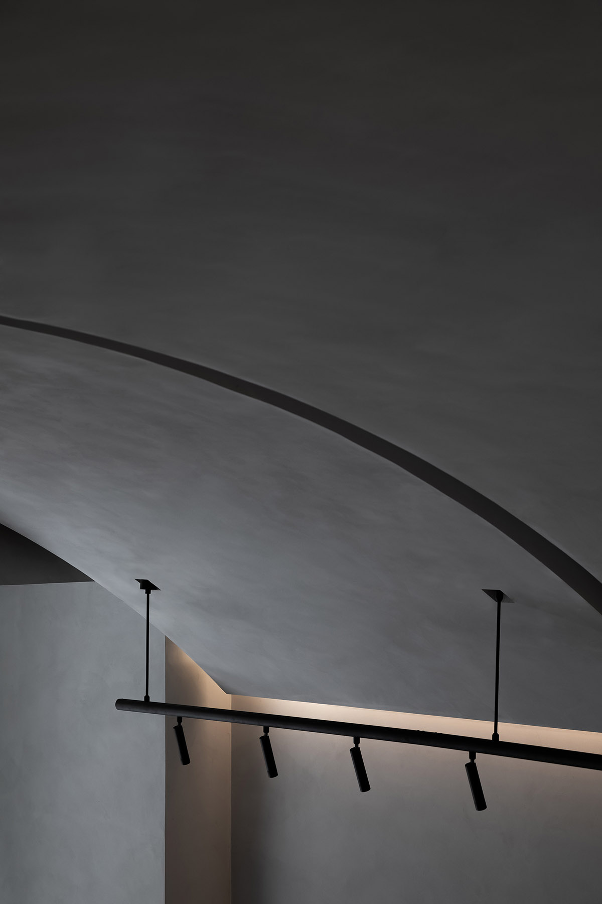 Grey and red colours combined with geometric shapes and shimmering ceiling for fashion store in China