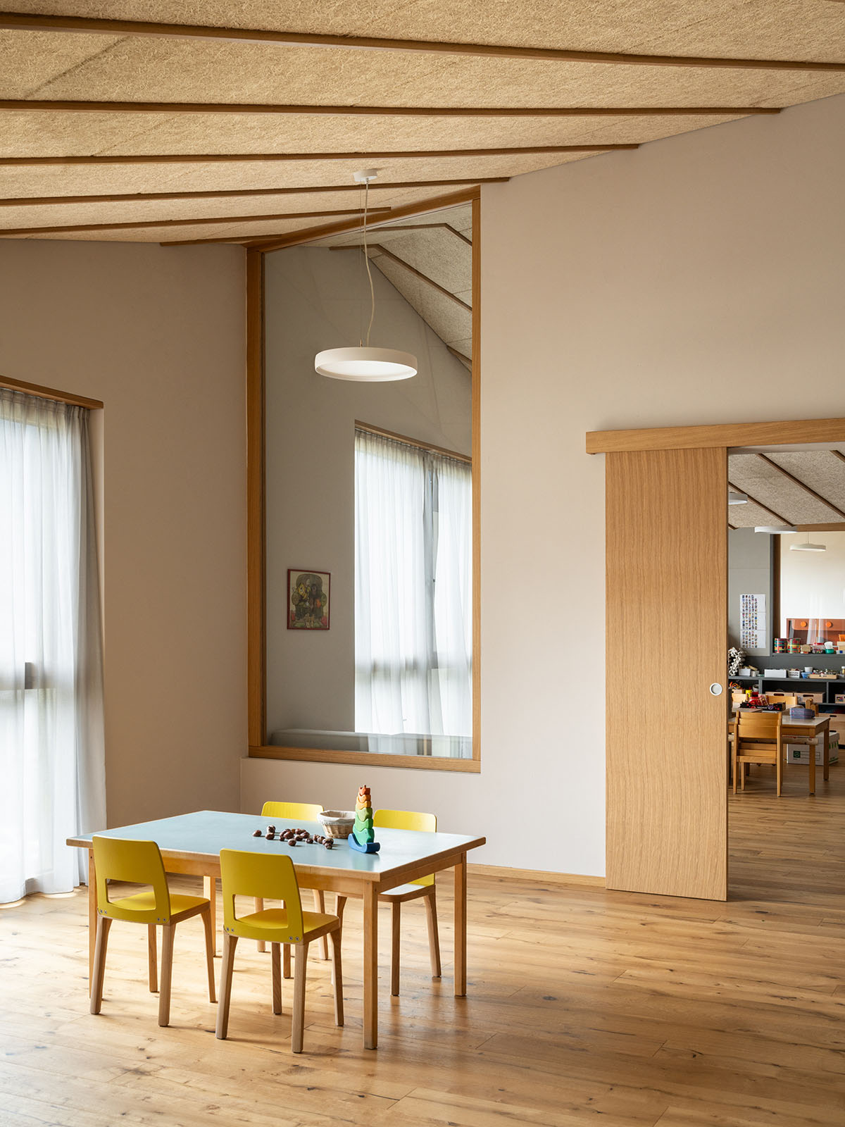 Zigzagged-profiled school featuring trapezoidal legs evokes traditional Tartan fabric in Terlano