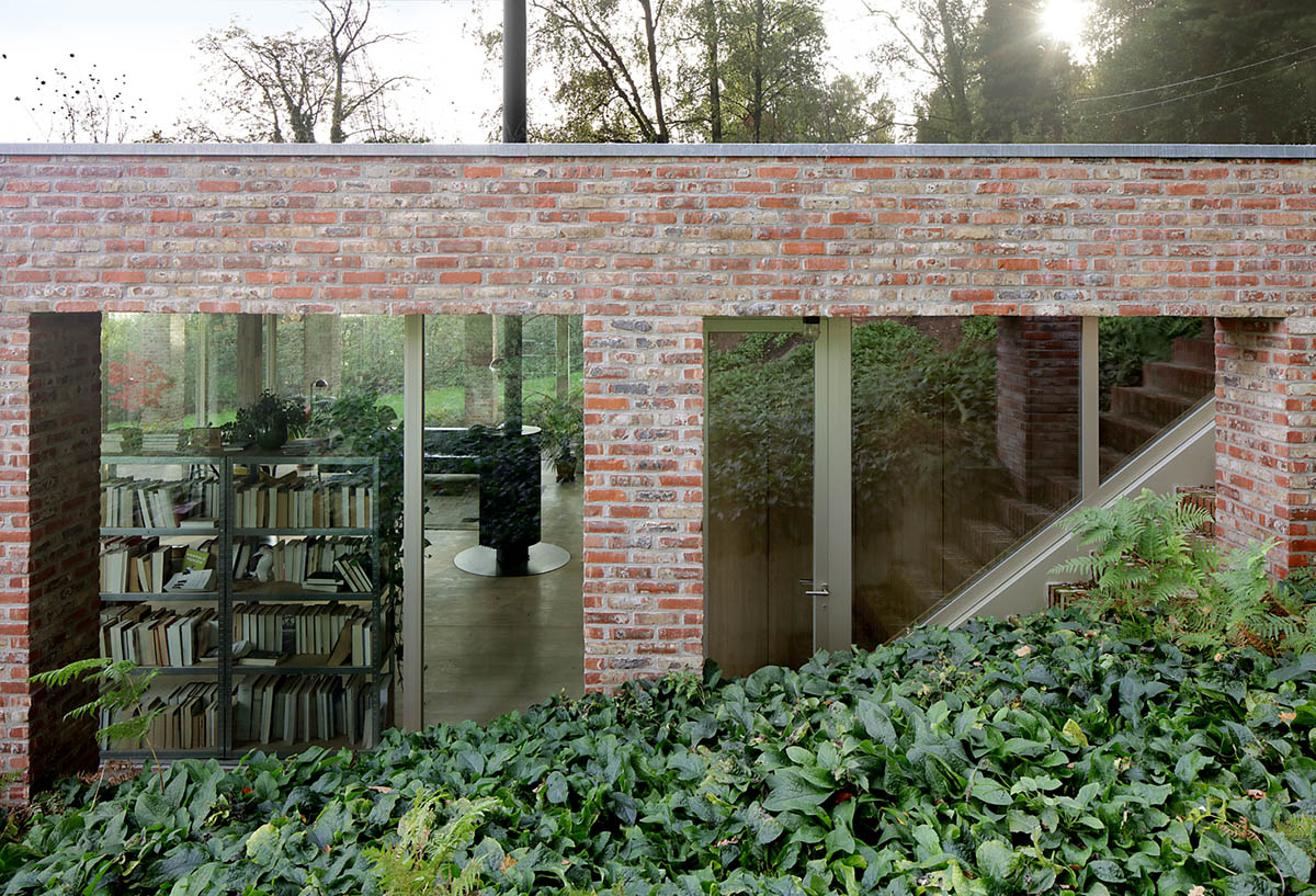 Studio Okami Architects built brick private villa embedded in the slope to offer infinite views