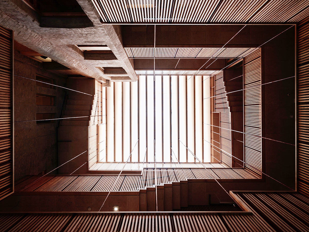 Atelier Oslo and KIMA Arkitektur restore former warehouse as a press house with light-lit atrium