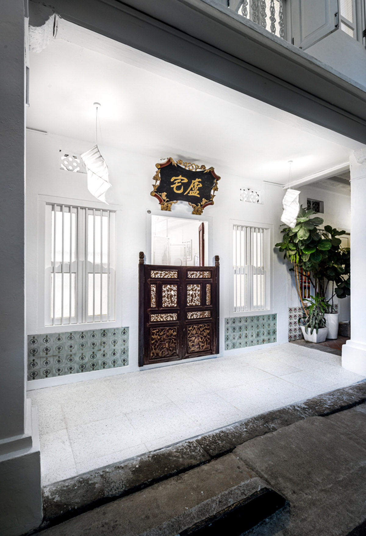 Ministry of Design transforms old dwelling in Singapore into co-living house with all-white interiors