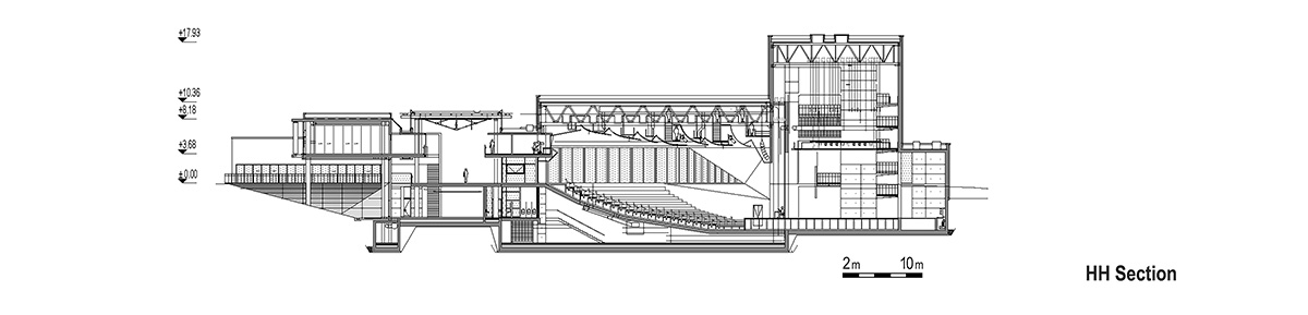 Uygur Architects articulates performing arts center façade with wooden triangulating surfaces