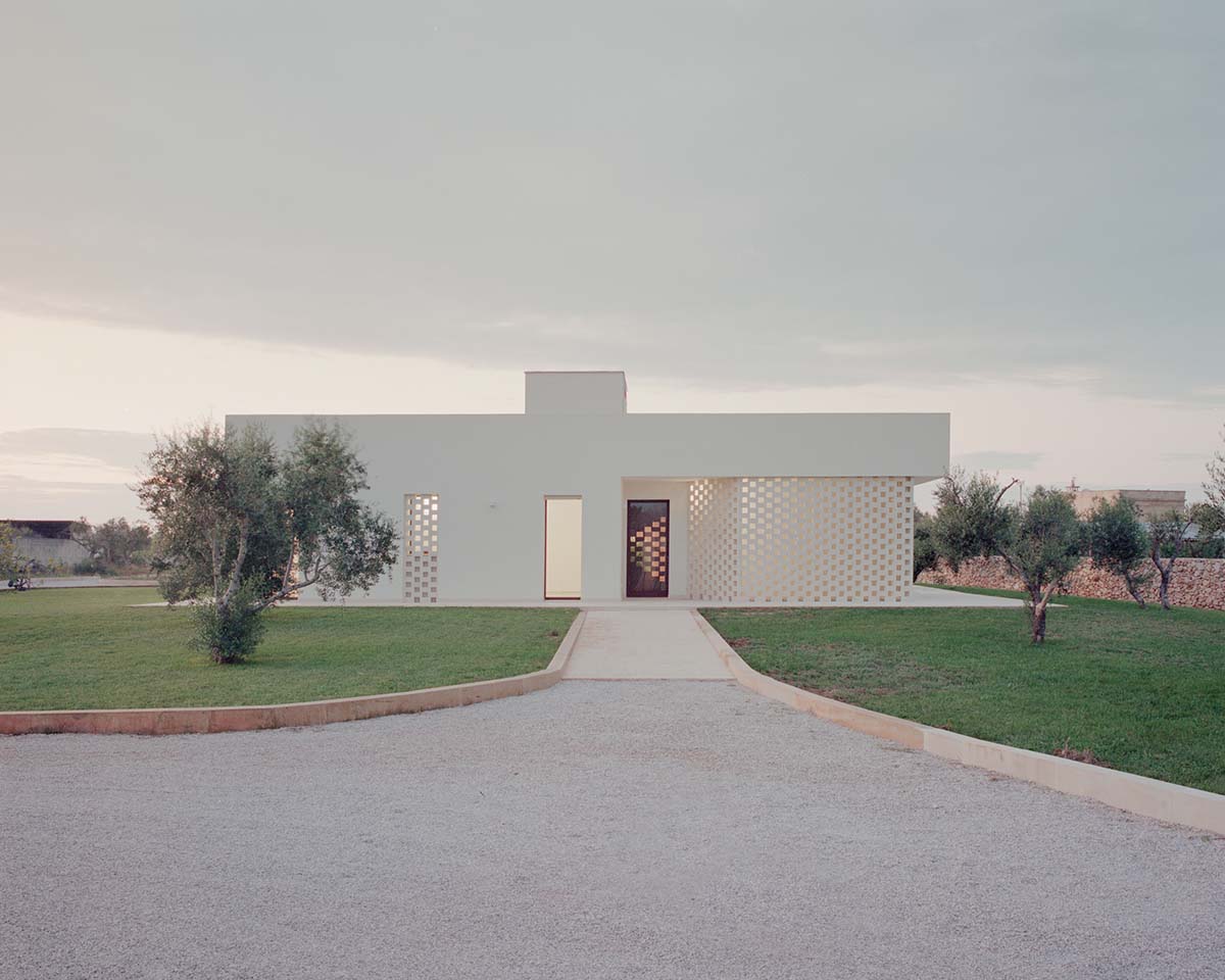 Rural retreat filters light through its stone porous screen in the Salento countryside