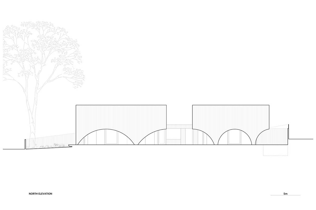 Arched concrete walls wrap a pair of houses as a secondary shelter in Australia