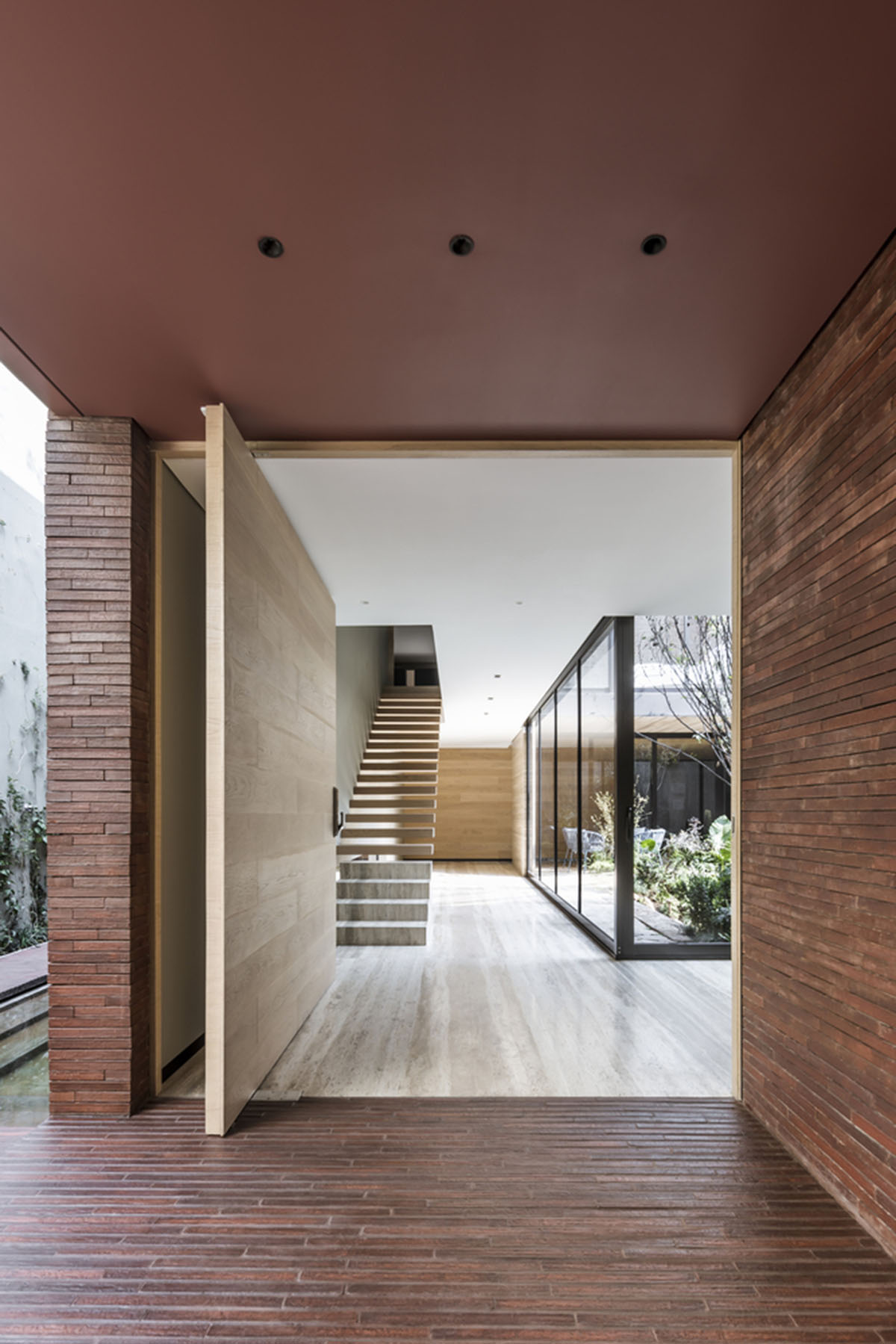 ESRAWE designs house by using red brick pavilion-like volumes in Mexico City