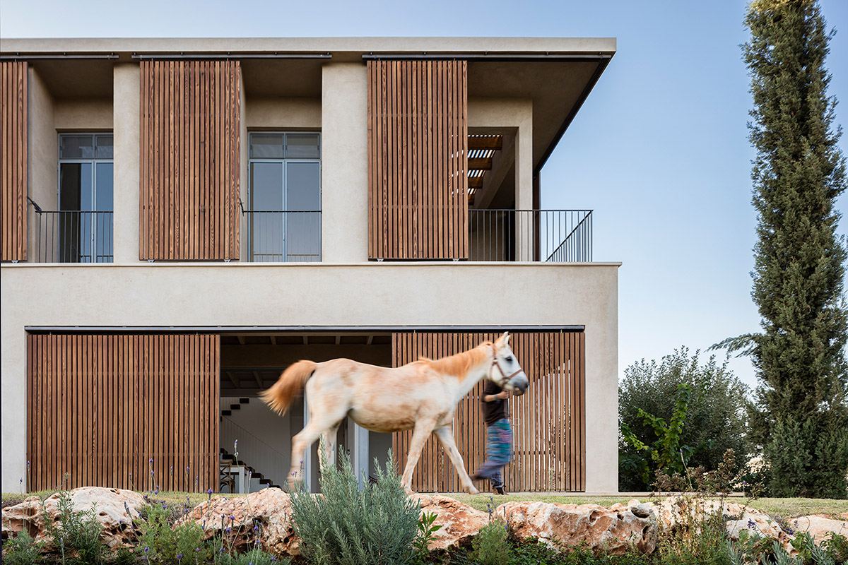 Golany Architects completes concrete private residence with wooden shutters in the Galilee