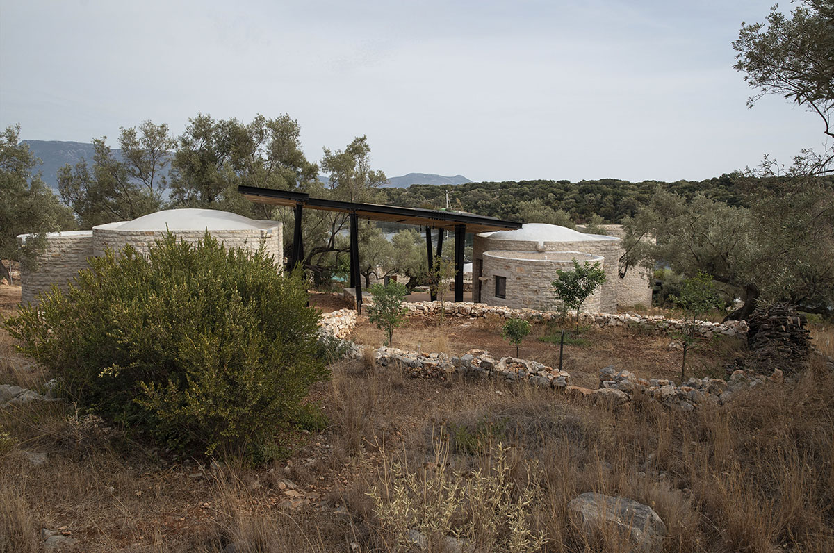 Pastoral round stone dwellings inform Meganisi House by Hiboux Architecture on Meganisi island