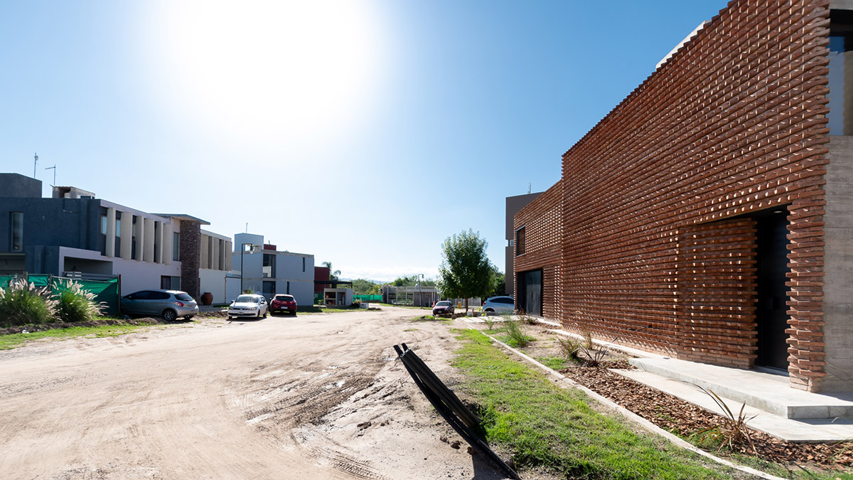 3D layer of brick wall wraps this family house to provide thermal comfort and special texture