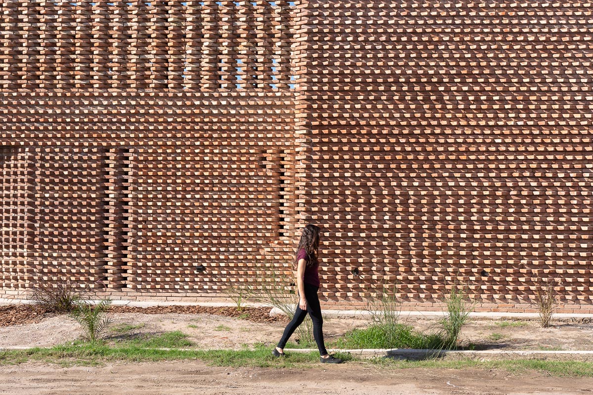 3D layer of brick wall wraps this family house to provide thermal comfort and special texture