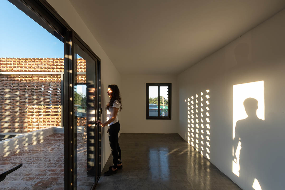 3D layer of brick wall wraps this family house to provide thermal comfort and special texture