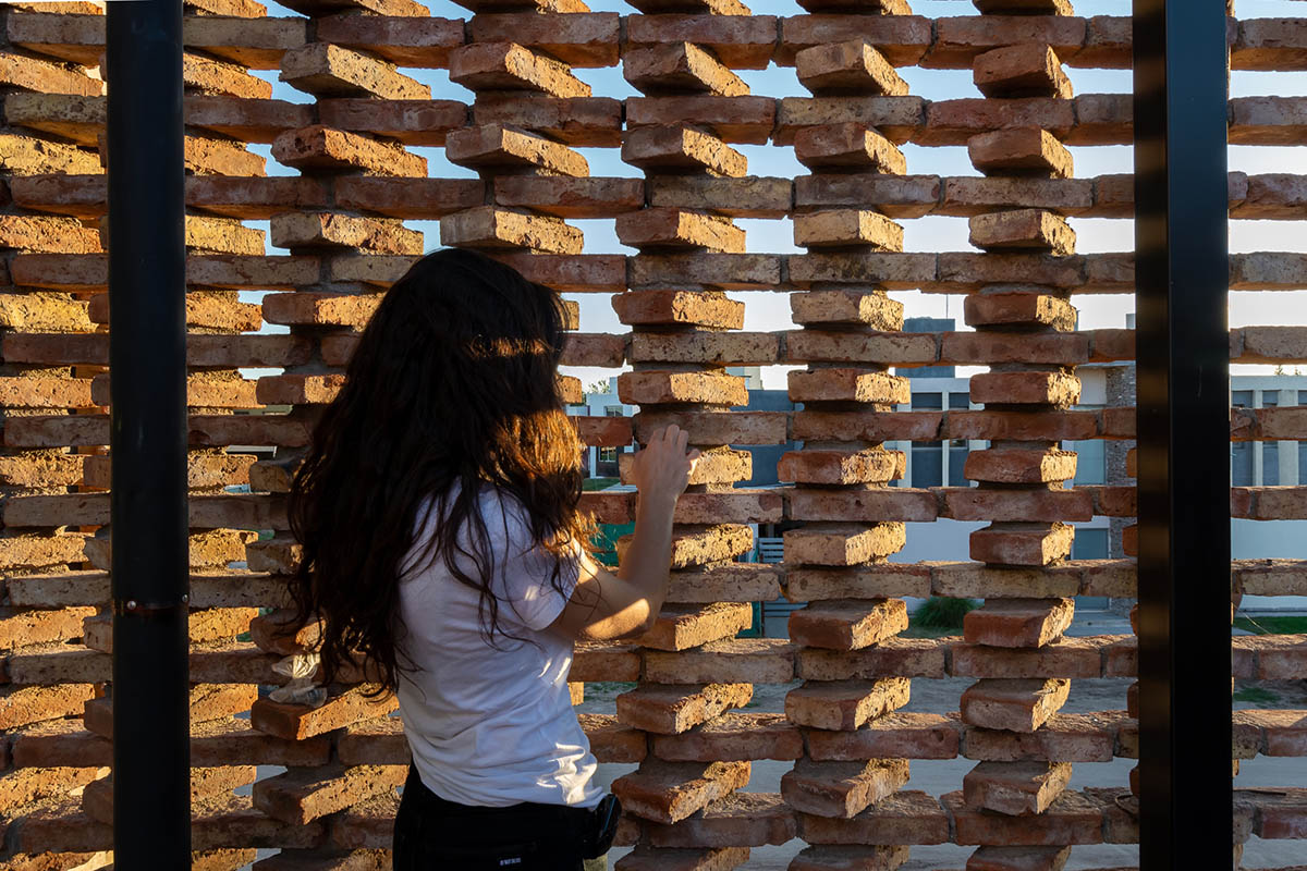 3D layer of brick wall wraps this family house to provide thermal comfort and special texture