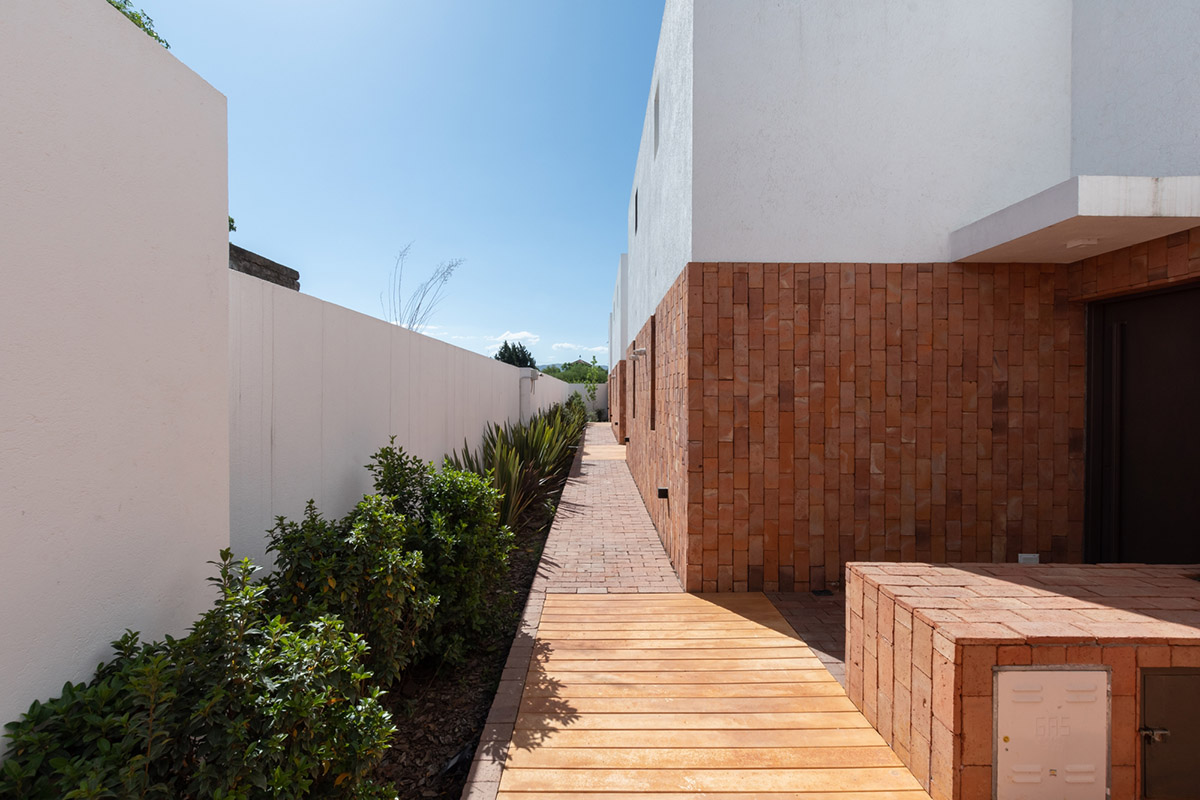 Andres Alonso Architecture Workshop completes La Inesita houses with tall brick base in Cordoba