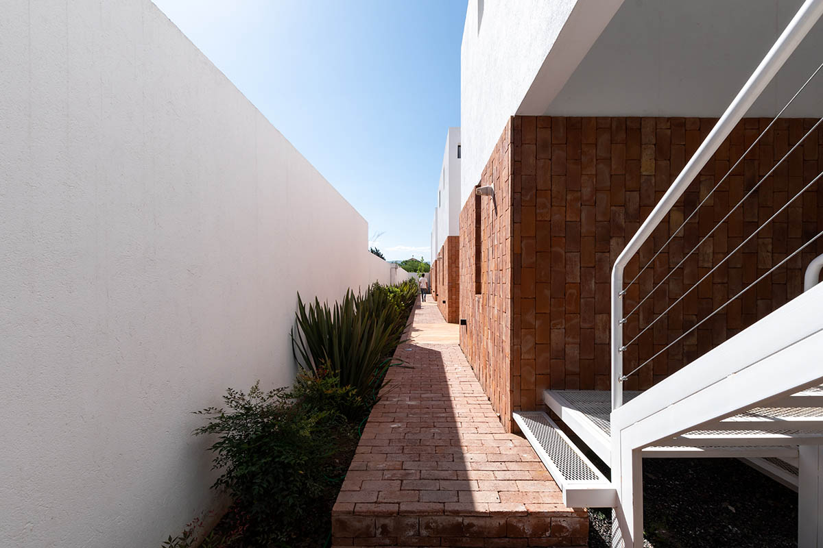 Andres Alonso Architecture Workshop completes La Inesita houses with tall brick base in Cordoba