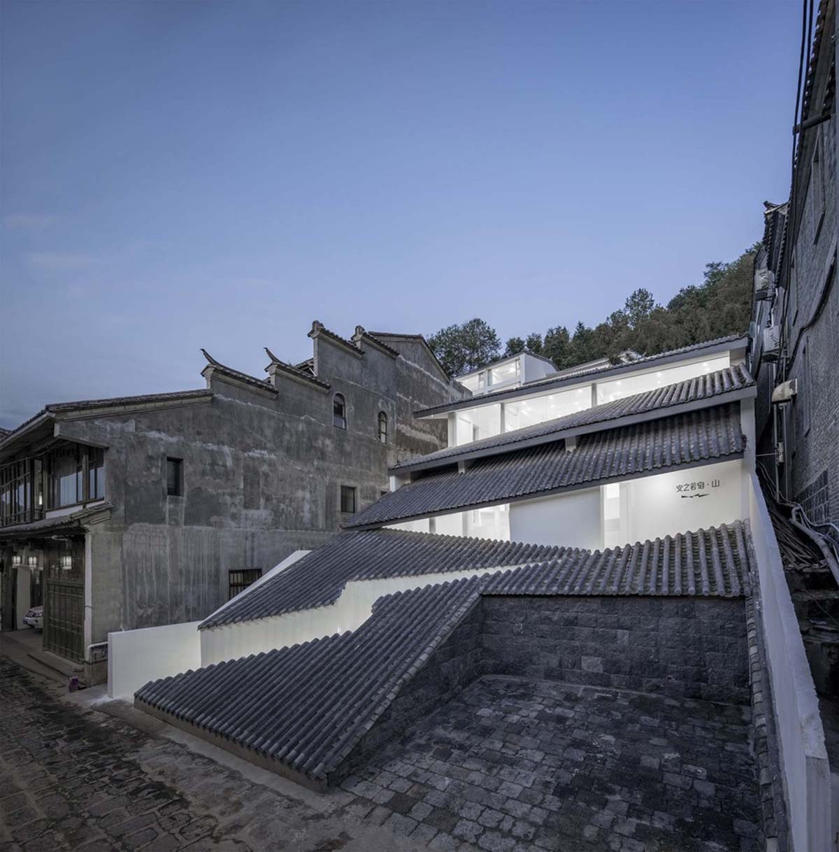 STUDIO QI reinterprets sequence of living conditions with tilted hotel on a hilly plot in China