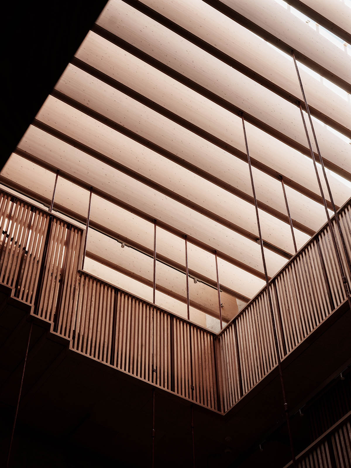 Atelier Oslo and KIMA Arkitektur restore former warehouse as a press house with light-lit atrium